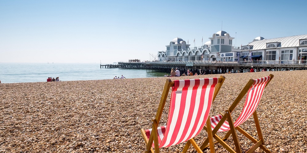 South Parade Pier, with deckchairs on the beach in the foreground